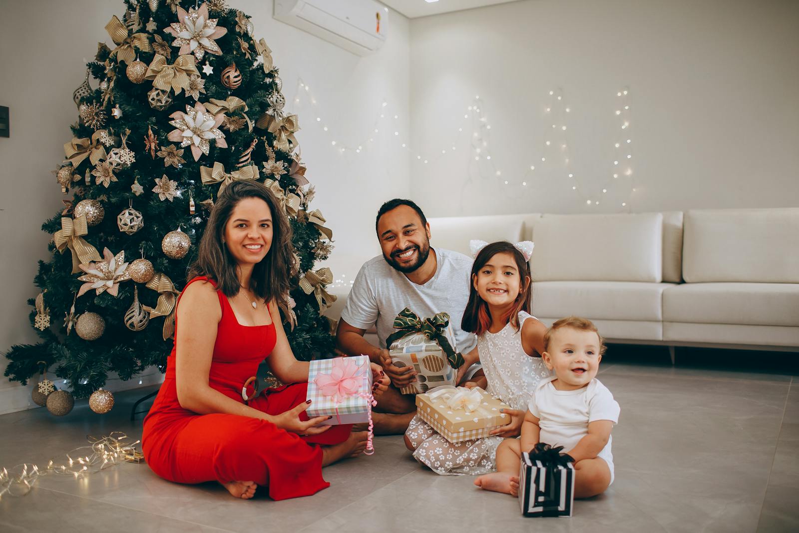Une joyeuse réunion de famille autour d'un arbre de Noël et échange des cadeaux à l'intérieur.